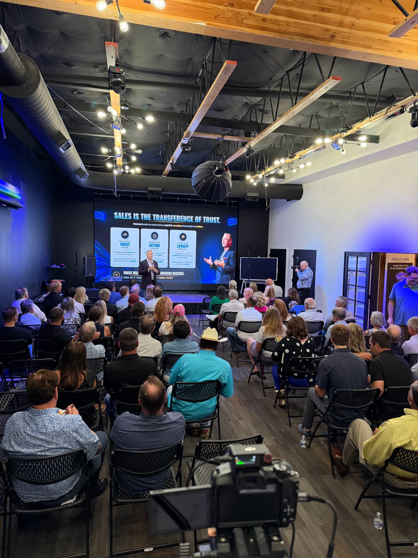 Wide view of the studio set up theater-style with lighting rig and cameras